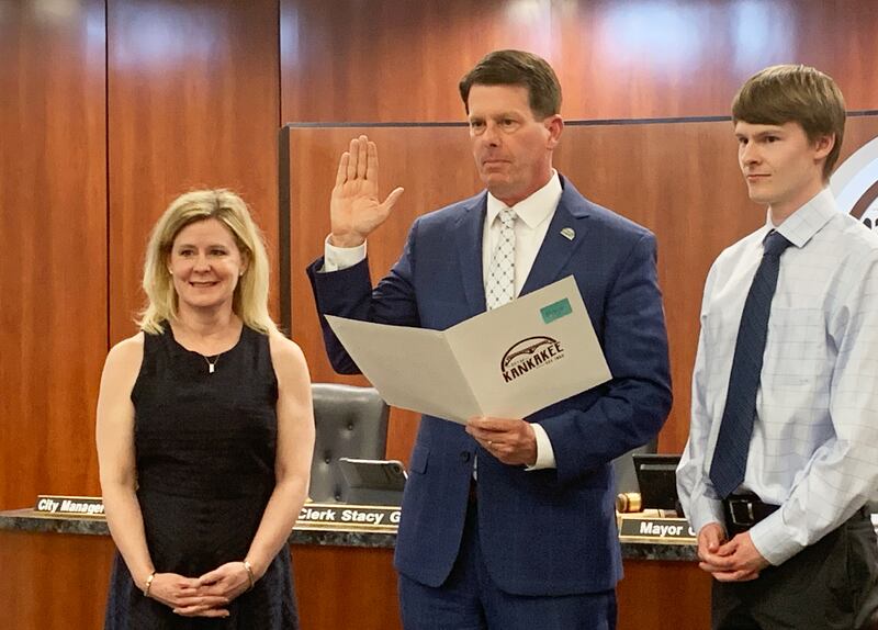 Kankakee Mayor Chris Curtis takes his oath of office next to his wife, Lori, and son Connor, 22, right, at the Kankakee City Council meeting on Monday, May 5, 2025.