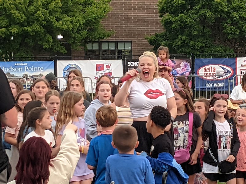 Charity Marie, lead singer of tribute band Beyond the Blonde, interacts with the crowd at Venue 1012 in Oswego on June 5.
