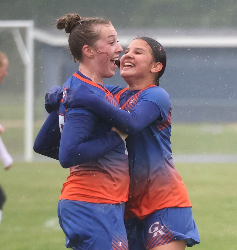 Genoa-Kingston’s Ally Poegel (left) and Ayva Hernandez celebrate after Poegel scored to put her team up 2-0 in their Class 2A regional final game against Rockford Christian Tuesday, May 20, 2025, at Rockford Christian High School.