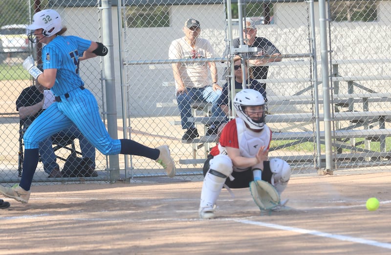 Marquette's Kelsey Cuchra scores a run as the ball arrives late to Henry-Senachwine catcher Addison Robbins on Thursday, April 23, 2026 at June Cross Field in Ottawa.