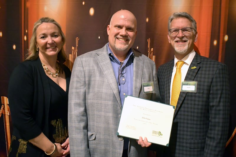 Will County Forest Preserve District Deputy Director and incoming Executive Director Tracy Chapman (from left), Volunteer of the Year John Fuqua, and current Executive Director Ralph Schultz at the annual volunteer banquet in April.