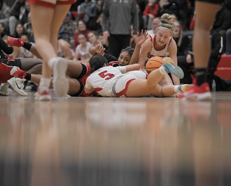 Benet’s Ava Thomas and Bridget Rifenburg, right, compete for the ball withe Bolingbrook’s Heaven Harris at the Class 4A East Aurora girls basketball sectional semifinal game on Tuesday, Feb. 24, 2026.