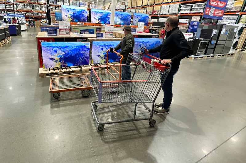FILE - Shoppers stop their carts to observe big-screen televisions on display in a Costco warehouse Thursday, April 30, 2026, in Timnath, Colo. (AP Photo/David Zalubowski, File)