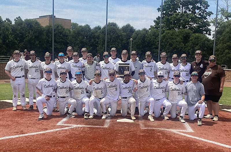 The Joliet Catholic baseball team poses with the plaque after beating Morris 8-2 to win the Class 3A Joliet Catholic Regional.