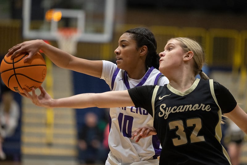 Plano’s Jailyn Brown and Sycamore’s Quinn Carrier reach for a loose ball Monday, Feb. 17, 2025, during a 3A semifinal in Sterling.