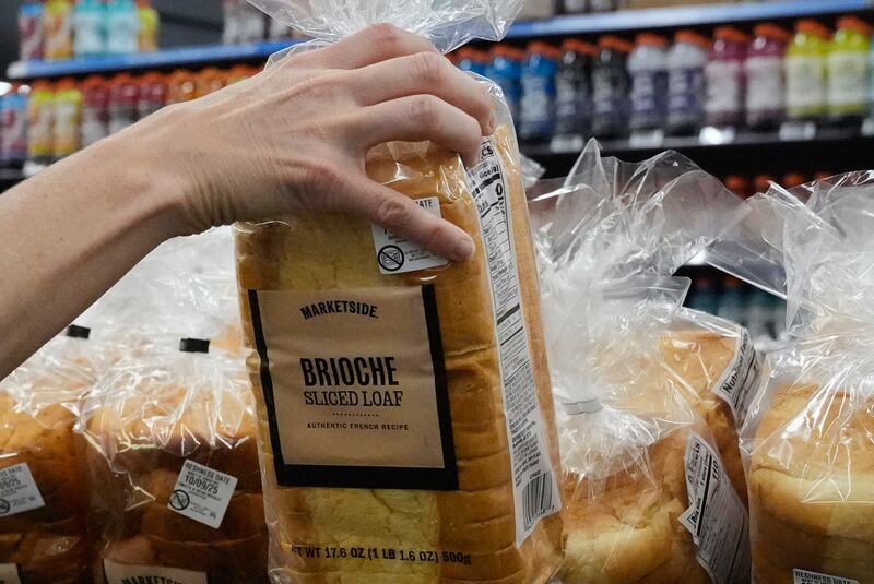 A customer reaches for a loaf of Marketside brand bread at a Walmart Neighborhood Market, Friday, Sept. 26, 2025, in Bentonville, Ark. (AP Photo/Charlie Riedel)