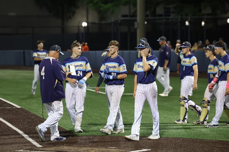 Marquette players gather on the field following the Crusaders' 6-1 loss to St. Joseph-Ogden in the IHSA Class 2A State semifinals on Friday, June 12, 2026, at the University of Illinois in Champaign.