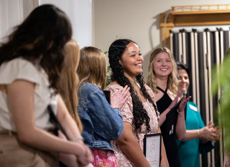 Young Woman of Tomorrow Award winner TyaSharri Collins smiles and is applauded Thursday, April 17, 2025, during the YWCA’s Women of Achievement Luncheon.