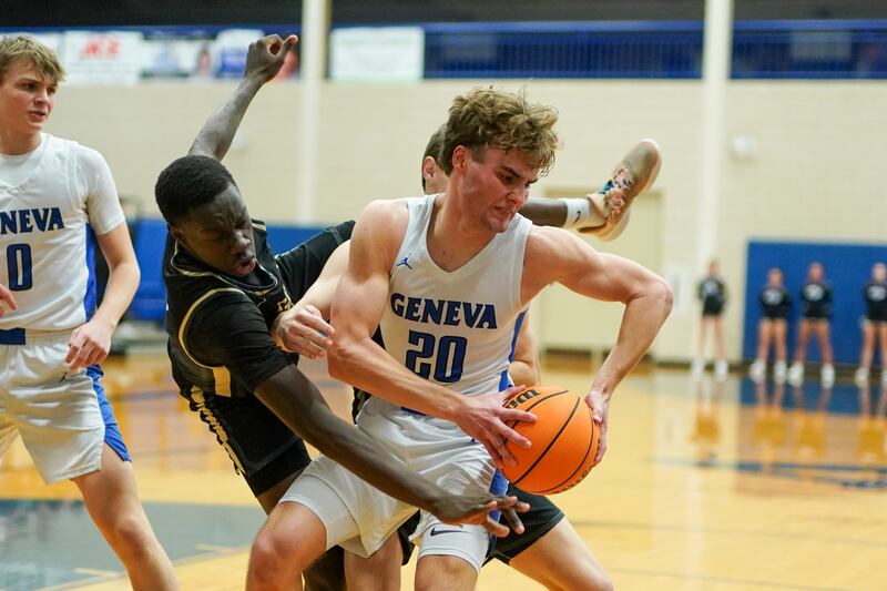 Geneva’s Jack Hatton (20) pulls down a rebound against Glenbard North's Oturo Redento (2) during a class 4A Geneva Regional final basketball game at Geneva High School on Friday, Feb. 28, 2025.