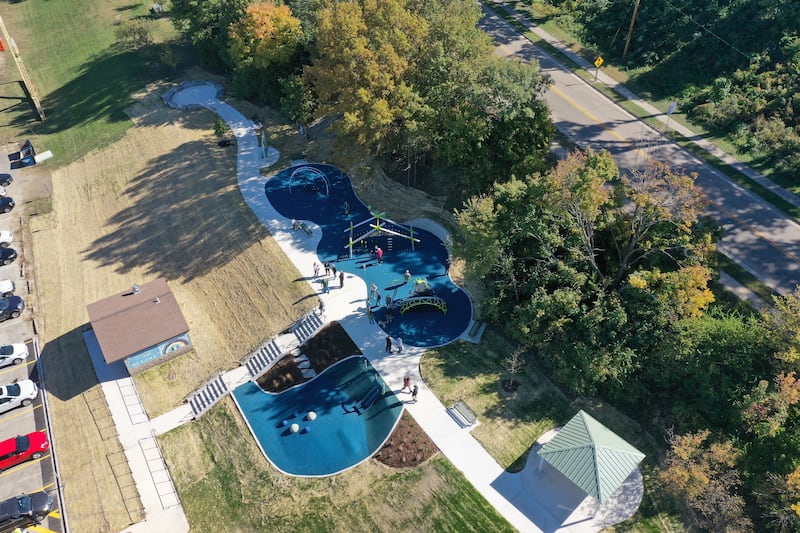 An aerial view of Allen Park during The City of Ottawa ribbon-cutting ceremony on Thursday, Oct. 17, 2024 in Ottawa. Commissioner Marla Pearson (center) cuts the ribbon on a 1.5 million dollar completion of a playground and other improvements to the park. The project was partially funded by a $506,000 IDNR Open Space Land Acquisition and Development grant. The new enhancements to Allen Park include accessible sidewalks leading to the upper plateau, featuring a modern playground and hillside play area with safe, poured-in-place surface for children of all abilities. The area also includes a shelter, bench swing with views of the Illinois River and a stone council ring for relaxation and community gatherings. 
A paved quarter-mile looped walking trail along the scenic banks of the Illinois River, two designated gaming areas, one with four bag toss stations and another with two chess-checkers tables and two ping-pong tables, all designed to promote social interaction and recreation. The sculptures will be repainted in the spring of 2025.