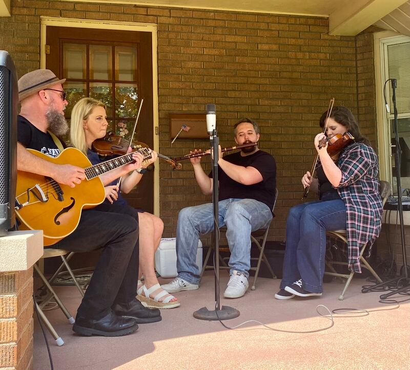 Local Irish music players perform on a Campbell St. porch at Porch & Park Music Fest 2024