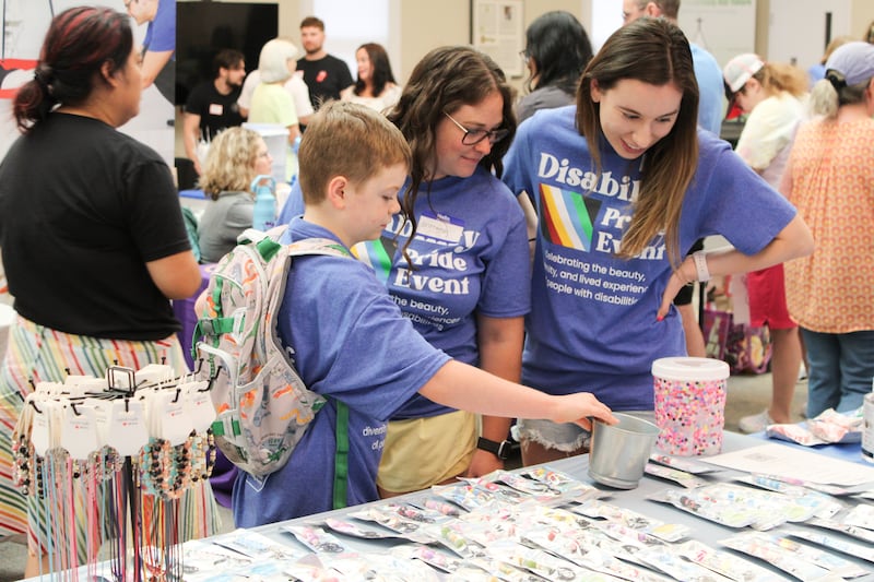 Attendees visit vendors booths at the first disability pride event in Crystal Lake on July 26, 2025.