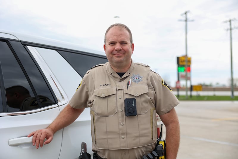 Kankakee County Sheriff's Deputy Sean Berry stands in the parking lot of Love's Travel Stop on Route 45 in south Kankakee where he witnessed the March 10 tornado pass through town.