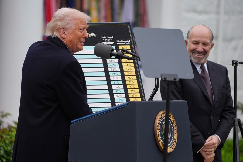 President Donald Trump speaks during an event to announce new tariffs in the Rose Garden of the White House, Wednesday, April 2, 2025, in Washington, as Commerce Secretary Howard Lutnick listens. (AP Photo/Evan Vucci)