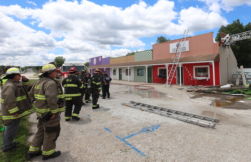 Firefighters work the scene of a fire inside the Starved Rock House of Jerky on Thursday, June 18, 2026 in Utica. The fire broke out just before noon. Fire departments from La Salle, Utica, Oglesby, Wallace and Tonica all responded to the scene.