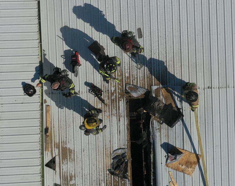 An aerial view of firefighters on top of a roof at Grassers Heating and Plumbing on Wednesday, Sept. 17, 2025 in McNabb. The fire began shortly before 10a.m. A Mutual Aid Box Alarm System (MABAS) was elevated to the fourth-alarm. No one was injured in the fire. Fire departments from McNabb, Peru, Utica, Henry, Ladd, Hennepin, Granville, Oglesby, Spring Valley, Leonore, Troy Grove, Seatonville, Wenona, Standard, Lacon-Sparland, Bureau and Tonica all responded to the scene. Firefighters left the scene at 11:30a.m.