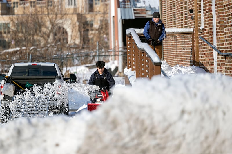 Isaac Kendrick (left) and Carson Leigh work to clear the sidewalk of Mad Water Saloon Sunday, Nov. 30, 2025, in Dixon.