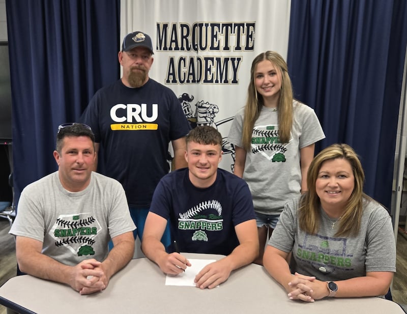 Marquette Academy’s Keaton Davis has committed to continue his academic career at Spoon River College in Canton and his baseball career at the NJCAA level with the Snappers. Pictured here is Davis bookended by his parents, Ronnie and Dawn Davis. Standing behind are Marquette baseball coach Todd Hopkins and sister Kaitlyn. Not pictured is sister Kennedy.