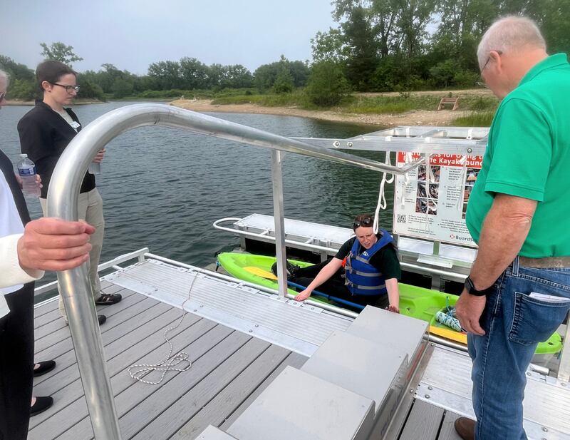 Bri Gulbrandsen of the McHenry County Conservation District demonstrates the new accessible kayak launch on June 12, 2025, at The Hollows Conservation Area in Cary.
