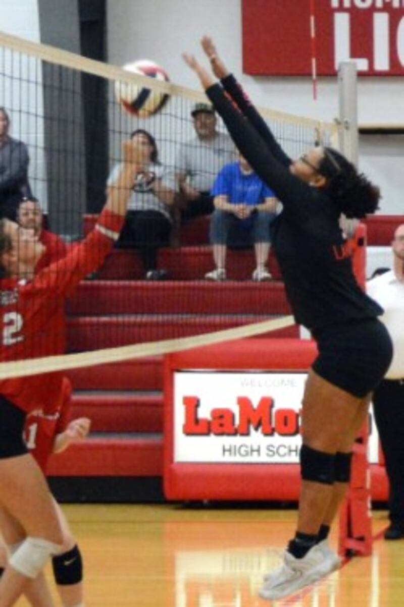 Indian Creek's Taylor Edwards (left) and LaMoille's Olivea Glasper battle at the net in Tuesday's Little Ten match in LaMoille. The Timberwolves won 25-20, 25-18.