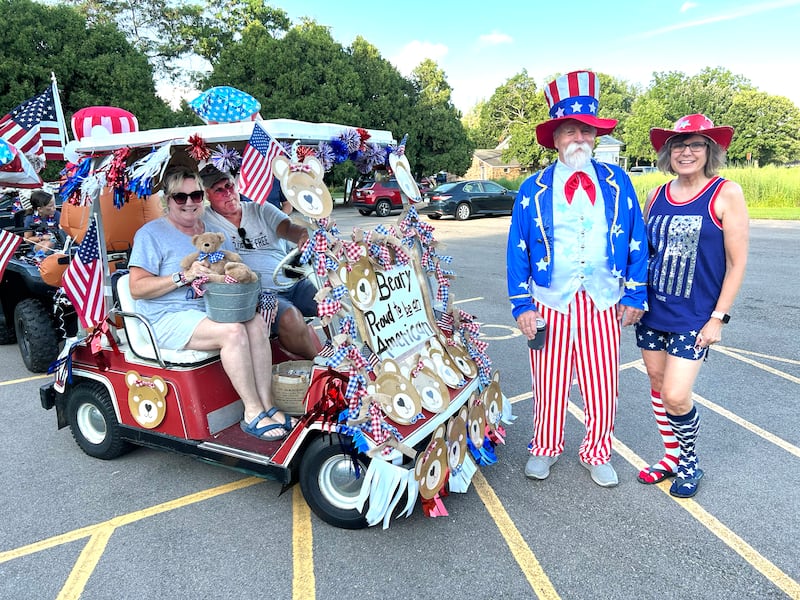 Jim Ross (Uncle Sam) and his wife, Connie (right) pose with Mark and Linda Downey and their "Beary Proud to be an American" decorated golf cart before the start of  the 7th Annual Grand Detour Golf Cart Parade on Sunday, July 6.