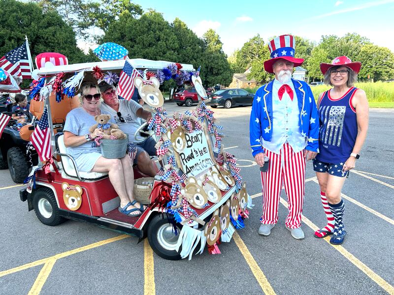 Jim Ross (Uncle Sam) and his wife, Connie (right) pose with Mark and Linda Downey and their "Beary Proud to be an American" decorated golf cart before the start of the 7th Annual Grand Detour Golf Cart Parade on Sunday, July 6.