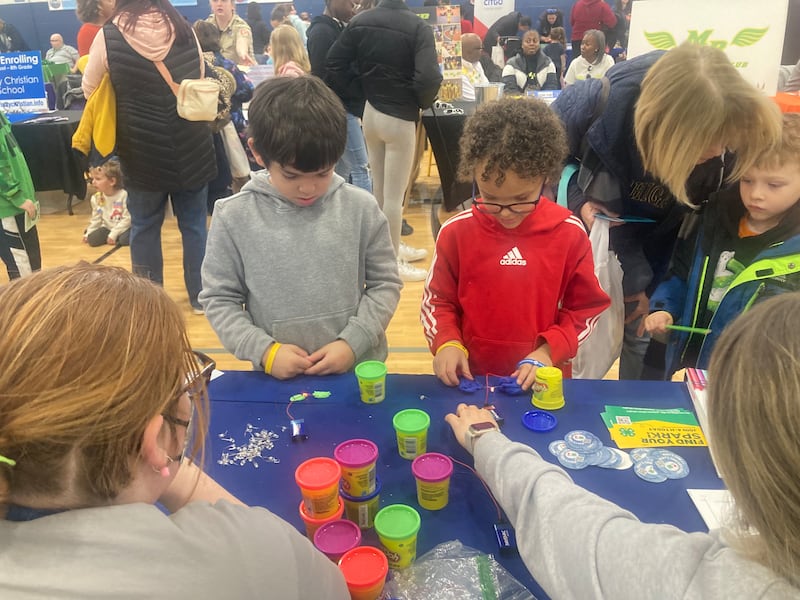 Justin Wood and Julian Salinas make "Play-Doh circuits" at the University of Illinois Extension booth at the Will County Kids Fair at Troy Middle School in Plainfield on Monday, Feb. 17, 2025.