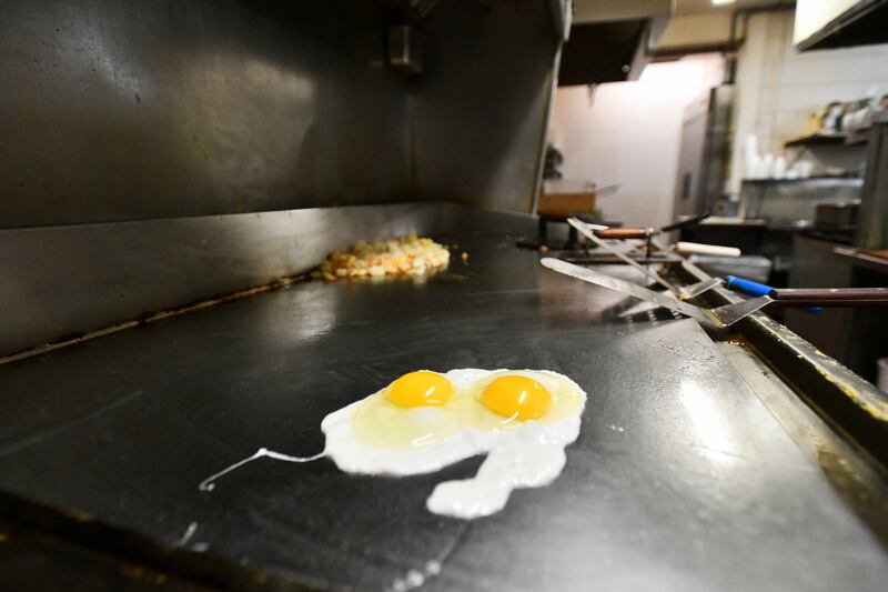 An order of fried eggs cook at Carlo's Restaurant in Kankakee during morning service on Feb. 25, 2025. Owner Jerrimy Robinson said since late October, the cost of eggs has increased by 150%.