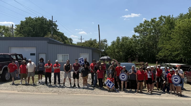 Picketing workers from UAW Local 904 stand outside HCC Inc. in search of a better four-year agreement with the agriculture manufacturer on Wednesday, May 27, 2026.