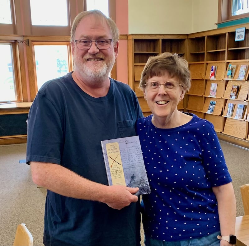 Rachael Mellen of Peru (right) shows off her new book, “From Camp Douglas to Vicksburg: The Civil War Letters of William J. Kennedy, 55th Infantry, 1861-1863,” with co-editor David Powell.