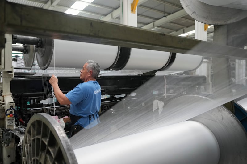 An employee works at a textile factory in Tlaxcala, Mexico, Tuesday, Feb. 4, 2025. (AP Photo/Eduardo Verdugo)