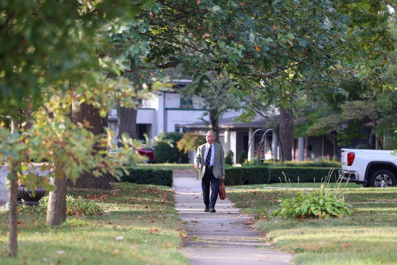Dennis Baron walks along Chicago Avenue on his way to his last day of work on Oct. 10, 2025.