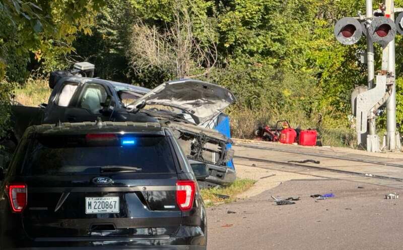 One person is dead and two others were injured Thursday morning when a freight train engine collided with a landscaping truck at the State Street crossing Elgin.