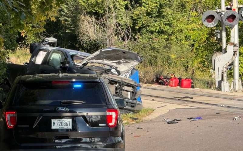 One person is dead and two others were injured Thursday morning when a freight train engine collided with a landscaping truck at the State Street crossing Elgin.
