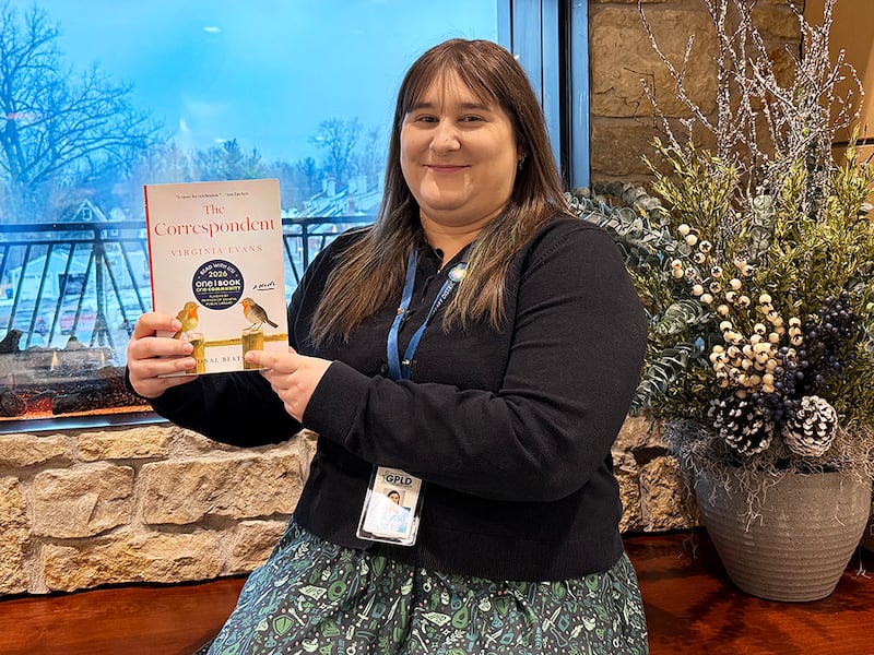 Adult and Teen Services Coordinator Allyson Palagi with this year's One Book, One Community selection, 'The Correspondent' by Virginia Evans.