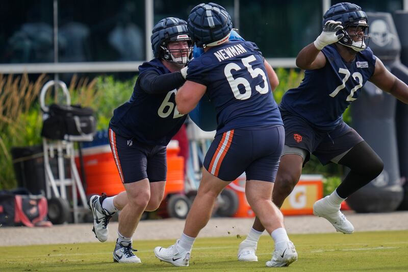 Chicago Bears guard Joe Thuney (62), left, and offensive tackle Luke Newman (65) work out during practice at the team’s NFL football training camp, Thursday, July 24, 2025, in Lake Forest, Ill. (AP Photo/Erin Hooley)