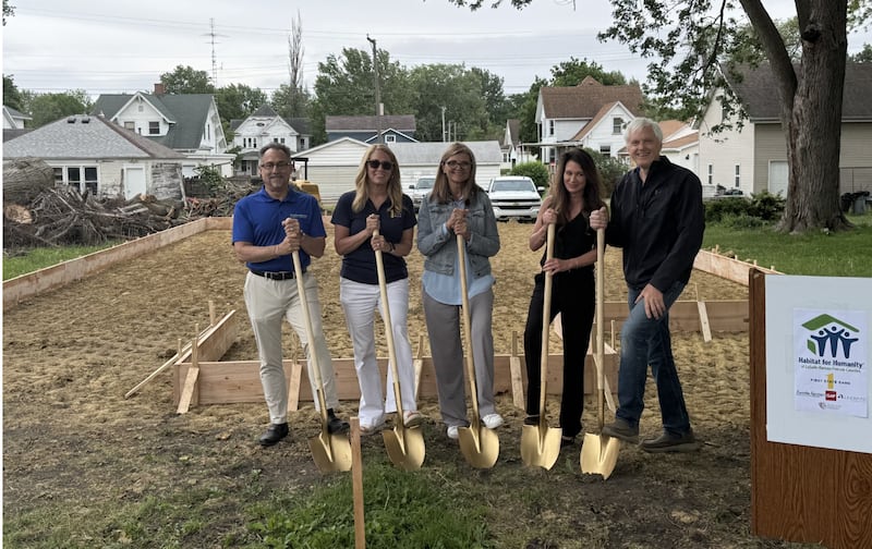 Jim Lobraco (Habitat for Humanity Board Treasurer), Jan Phalen (First State Bank CMO), Emily McConville (Mendota Economic Development Director), Jessica Brayfield (Habitat for Humanity Executive Director), and Marty Wineinger (Habitat Board President) conclude the first day of progress on the development site at 1205 Jefferson St. in Mendota with a ceremonial shovel dig at the Tuesday, May 19, 2026, ground-breaking ceremony.