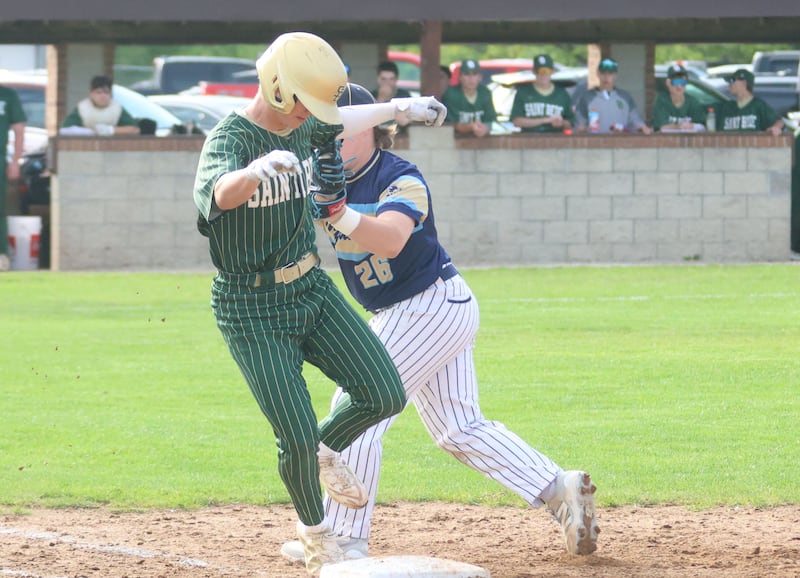 Marquette's Braxton Nelle tags out St. Bede's Geno Dinges at first base on Tuesday, April 28, 2026 at Masinelli Field in Ottawa.