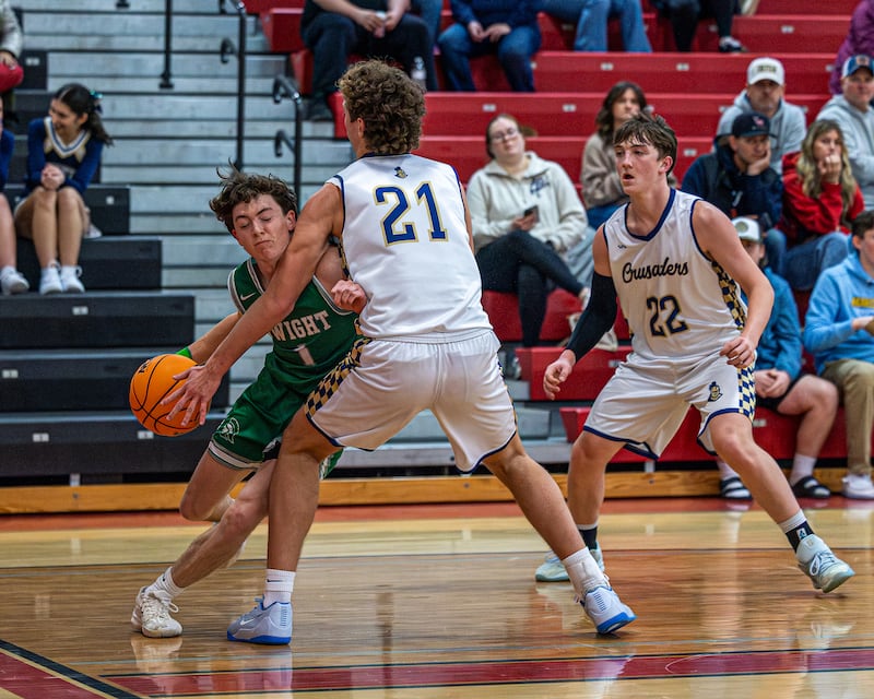 Dwight's Joe Duffy (1) drives ball baseline colliding with Lucas Craig (21) of Marquette on Saturday, Feb. 21, 2026 at Marseilles Elementary School.