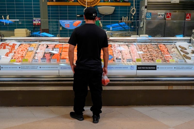 A person looks at the fresh fish at a grocery store Monday, May 11, 2026, in Nashville, Tenn. (AP Photo/George Walker IV)