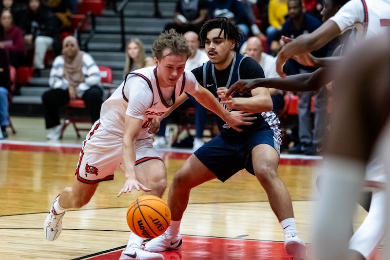 Bolingbrook's Trey Brost drives to the basket during a varsity boys basketball game against Oswego East at Bolingbrook on Dec. 12, 2025.