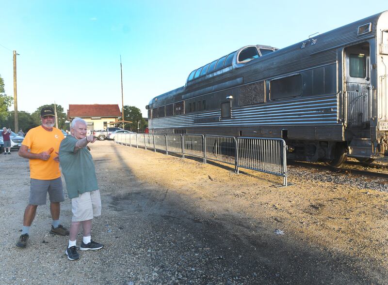 Mike Abernethy of St. Charles and Oregon Museum Board Member Roger Cain watch as the Silver View dome car reaches its new home west of the Oregon Depot in August 2022.