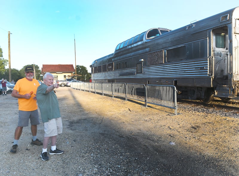 Mike Abernethy of St. Charles and Oregon Museum Board Member Roger Cain watch as the Silver View dome car reaches its new home west of the Oregon Depot in August 2022.