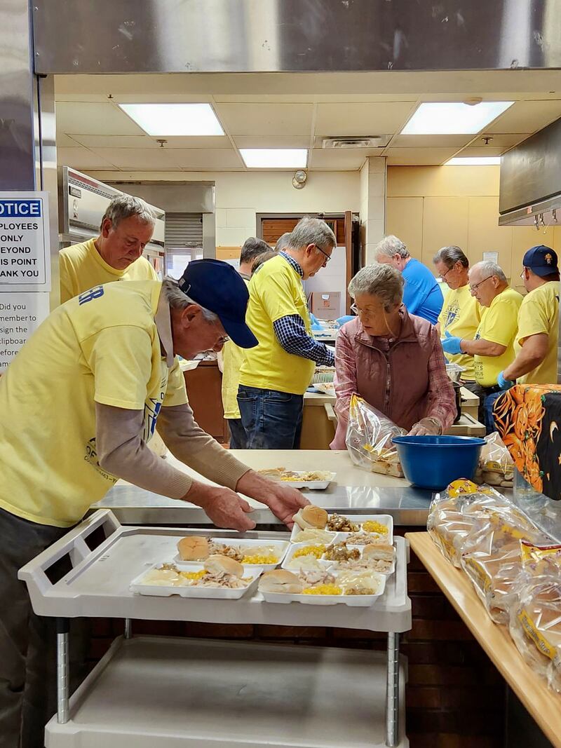 Volunteers from the Knights and Lady Knights of Columbus prepare more than 150 Thanksgiving meals for hungry and thankful seniors at the Beecher Center in Yorkville.