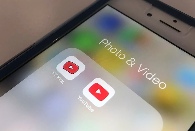 FILE - The icons for the YouTube Kids and YouTube apps are displayed on a smartphone in New York on April 25, 2018. (AP Photo/Jenny Kane, File)