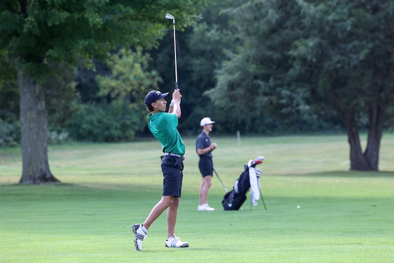 Bishop McNamara's Nolan Andrews watches his ball alongside Bradley-Bourbonnais' Max LaMore during the All-City matchup on Wednesday, Sept. 24, 2025. The Fightin' Irish earned a 3-point victory over the Boilermakers with a 339-342 final score.