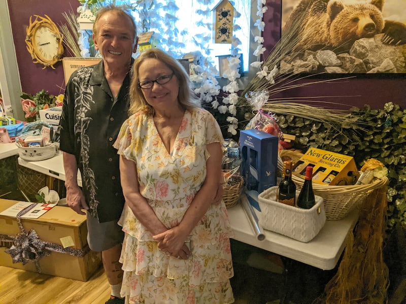 The Pets' Home owners John and Laura Gay stand in front of some of the items that have been donated for their May 17 adoption event.