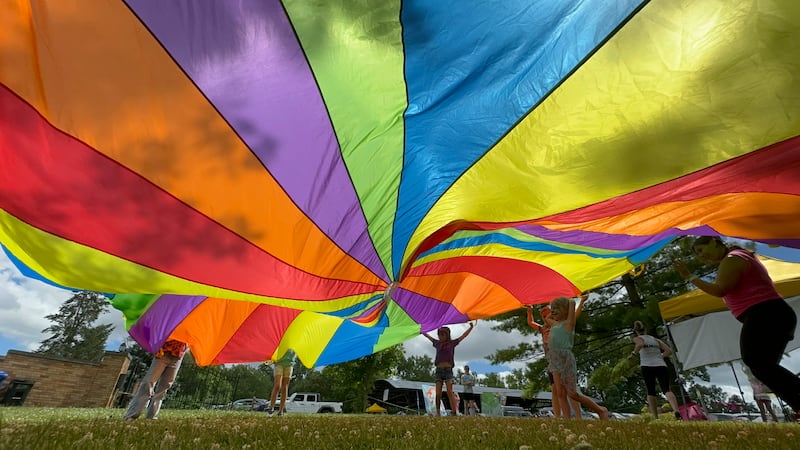 Children play a parachute game at a past year's Oneness Fest at Good Templar Park in Geneva. This year's event is from June 20-22.