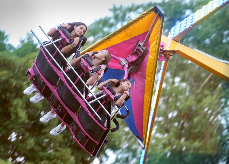 A group of girls enjoy a carnival ride during the 83rd Montgomery Fest on Saturday, Aug. 19, 2023.