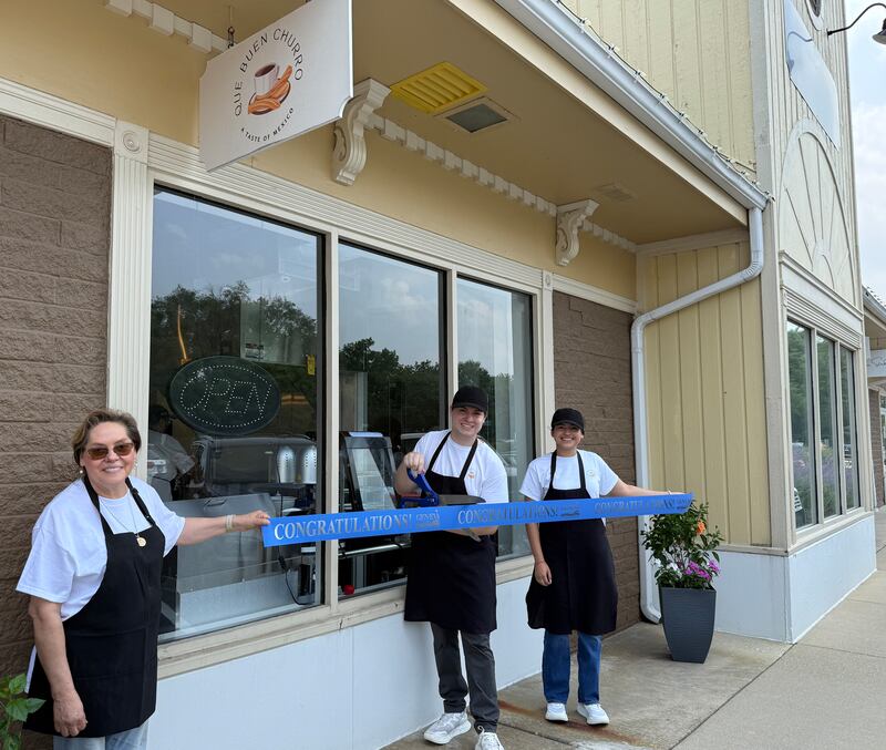 Peter Pacheco (center) cuts the ribbon on Que Buen Churro, 316 Crescent Place, Geneva Aug. 1 with his mother, Alma Pacheco, (left) and his girlfriend Melissa Hernandez. The three run the new store, which sells handmade churros.